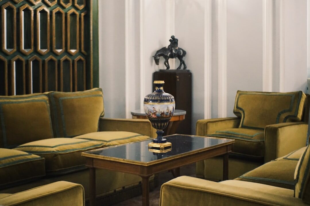 Elegant 1980s style luxury living room with velvet sofas and brass accents